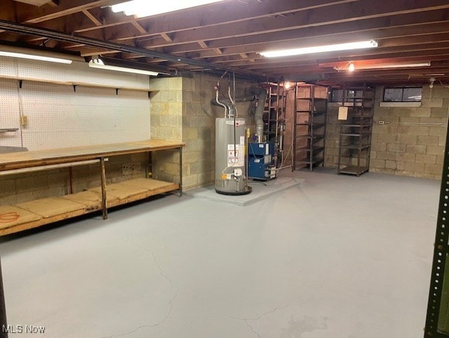 basement with a workshop area and water heater