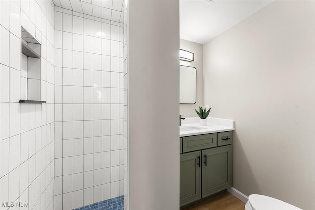 bathroom with vanity, wood-type flooring, toilet, and walk in shower