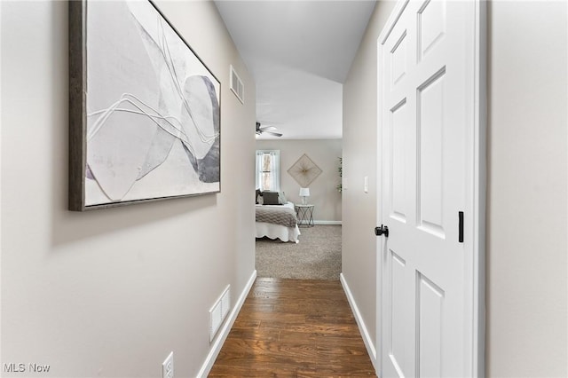 corridor featuring dark hardwood / wood-style flooring