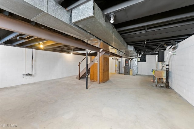 basement with gas water heater, sink, and heating unit