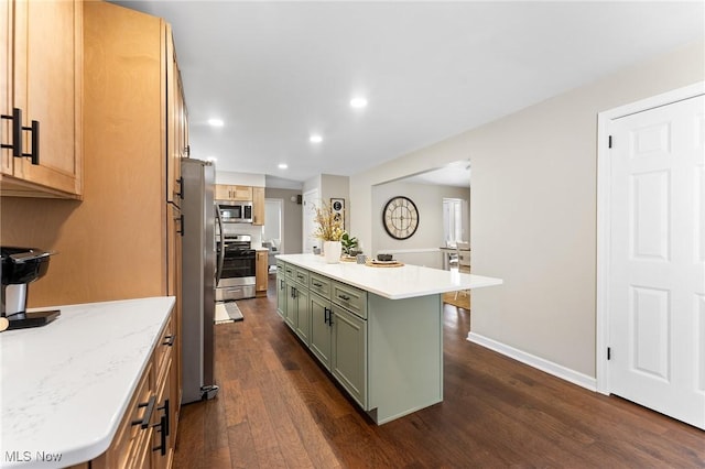 kitchen with stainless steel appliances, a kitchen island, dark hardwood / wood-style floors, and green cabinets