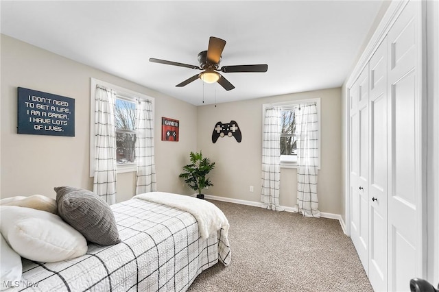 bedroom with ceiling fan, carpet floors, and a closet