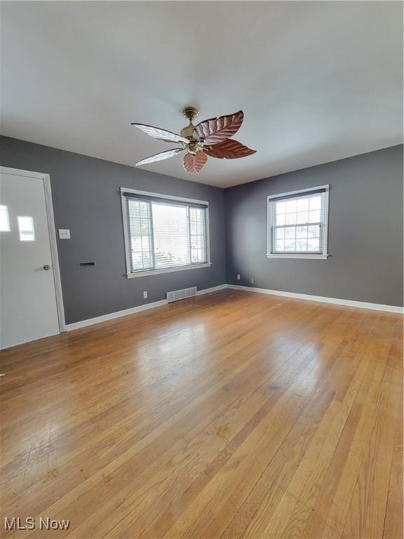 empty room featuring ceiling fan and light hardwood / wood-style floors