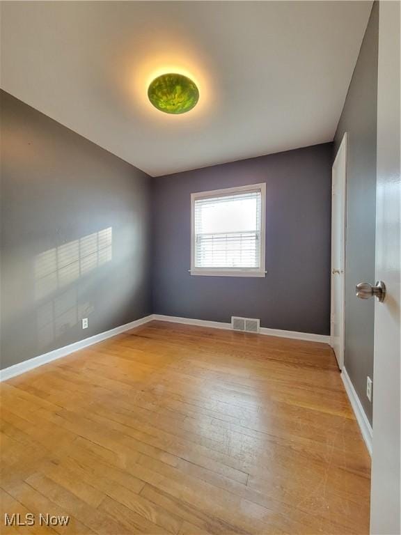 spare room featuring light hardwood / wood-style floors