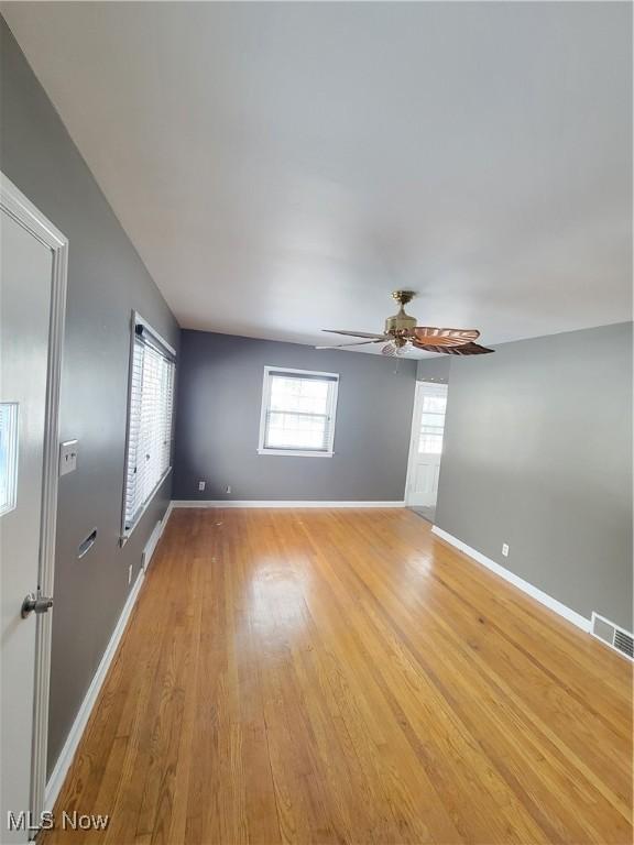 unfurnished room with ceiling fan and light hardwood / wood-style flooring