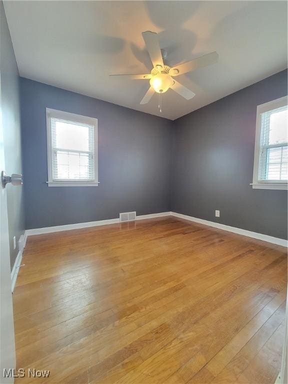 spare room with light hardwood / wood-style flooring and ceiling fan