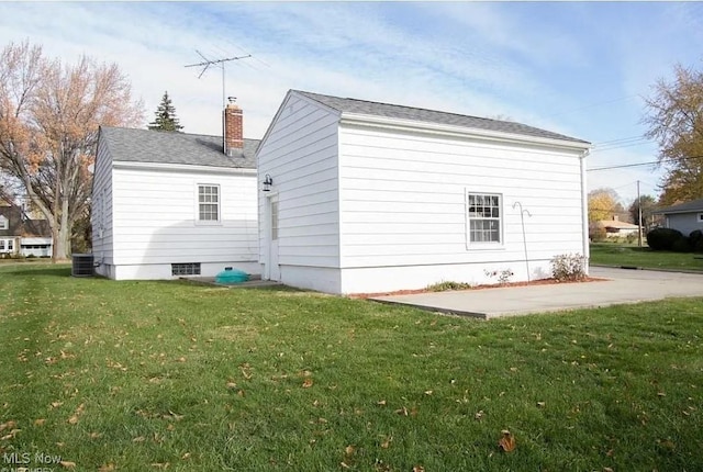 view of side of home with a patio, central air condition unit, and a lawn