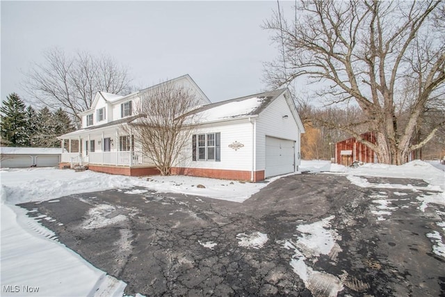 view of front of house featuring a garage and covered porch