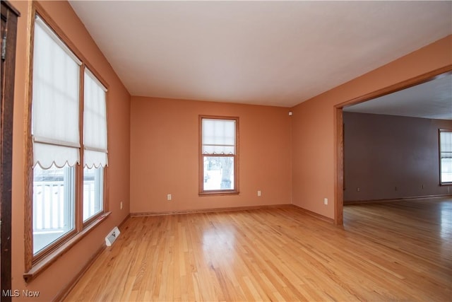 empty room with light hardwood / wood-style floors