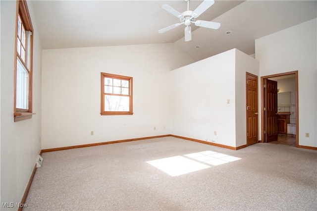 carpeted spare room featuring lofted ceiling, plenty of natural light, and ceiling fan