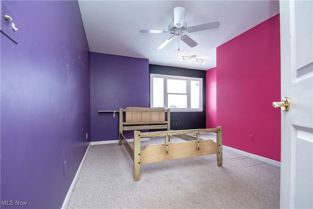 bedroom with ceiling fan, rail lighting, and carpet