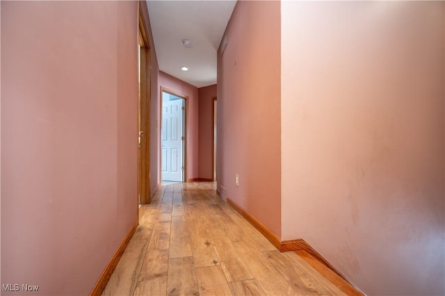 corridor with light hardwood / wood-style floors