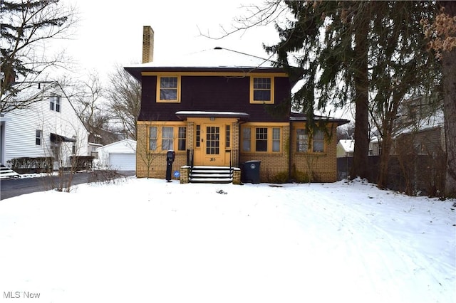 view of front facade featuring a garage and an outdoor structure