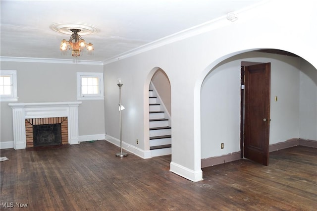 unfurnished living room featuring crown molding, a brick fireplace, and dark hardwood / wood-style floors