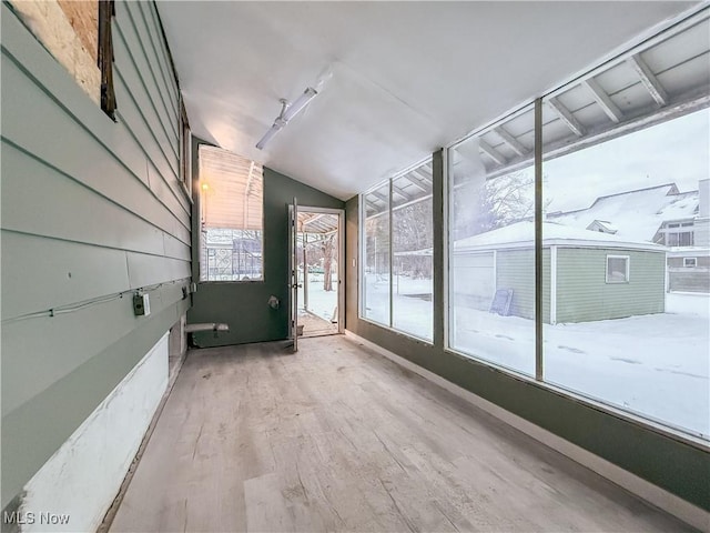 interior space featuring vaulted ceiling and light hardwood / wood-style floors