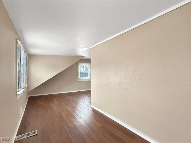 bonus room with vaulted ceiling and hardwood / wood-style floors