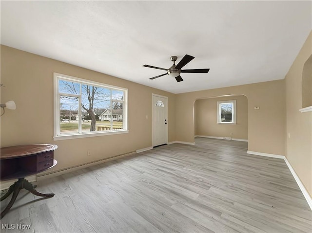 unfurnished living room featuring light hardwood / wood-style floors and ceiling fan