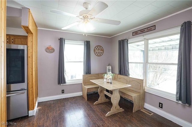 dining room with crown molding, ceiling fan, and dark hardwood / wood-style flooring