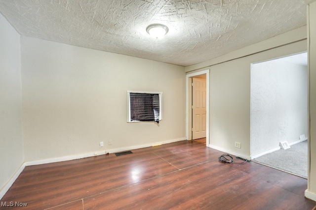 empty room with dark hardwood / wood-style flooring