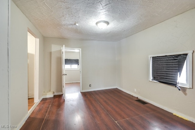 unfurnished room featuring dark hardwood / wood-style floors