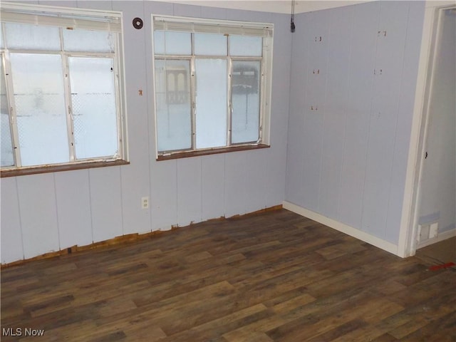 empty room featuring dark wood-type flooring