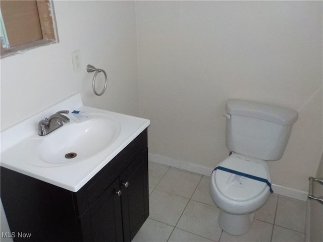 bathroom with vanity, tile patterned floors, and toilet