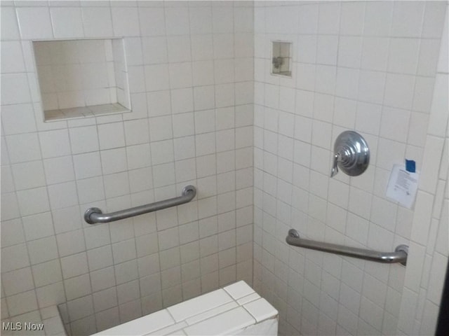 bathroom with tiled shower