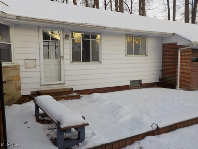 view of snow covered property entrance