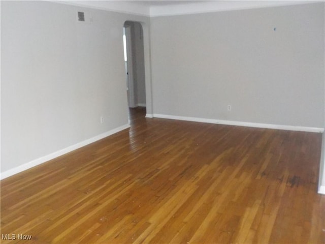 unfurnished room featuring dark hardwood / wood-style flooring