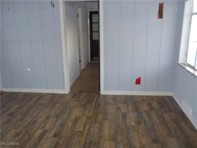 empty room with dark hardwood / wood-style floors