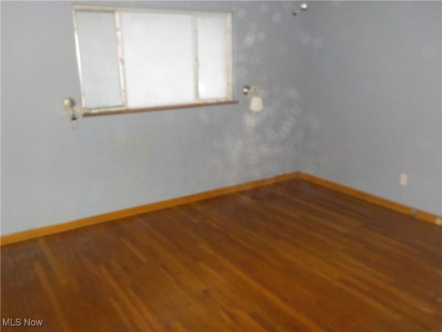 empty room with hardwood / wood-style floors