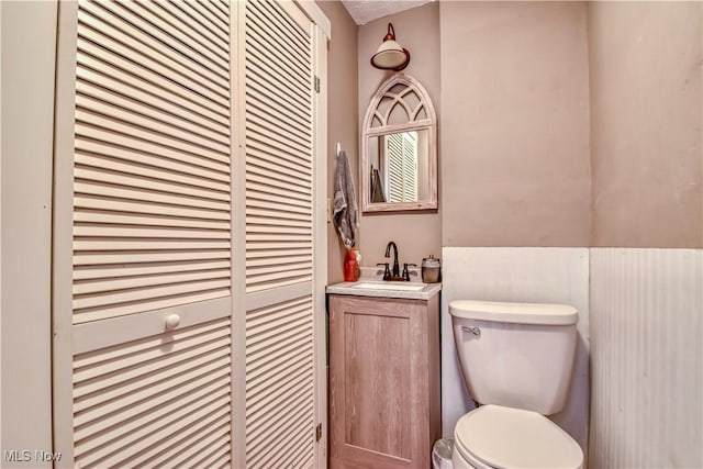 bathroom featuring vanity and toilet