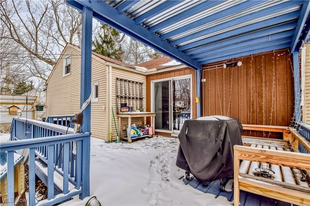 snow covered patio with area for grilling