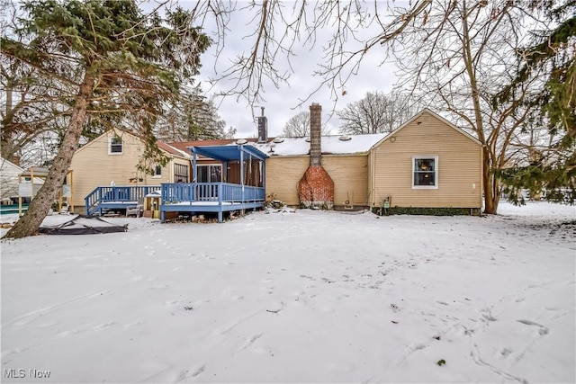 snow covered property featuring a wooden deck