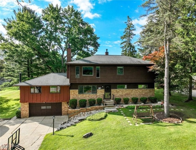 view of front of home with a garage and a front yard