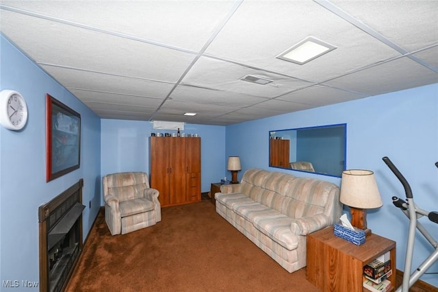 carpeted living room featuring a paneled ceiling