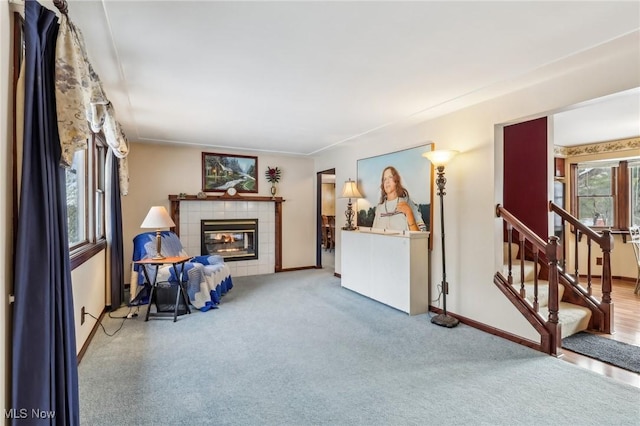 living room with carpet and a fireplace