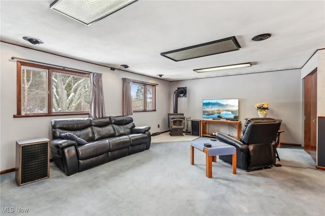 carpeted living room featuring a wood stove