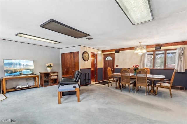 living room with carpet floors and a chandelier