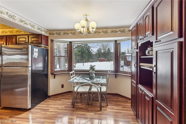 kitchen featuring a chandelier, stainless steel refrigerator, and light hardwood / wood-style flooring