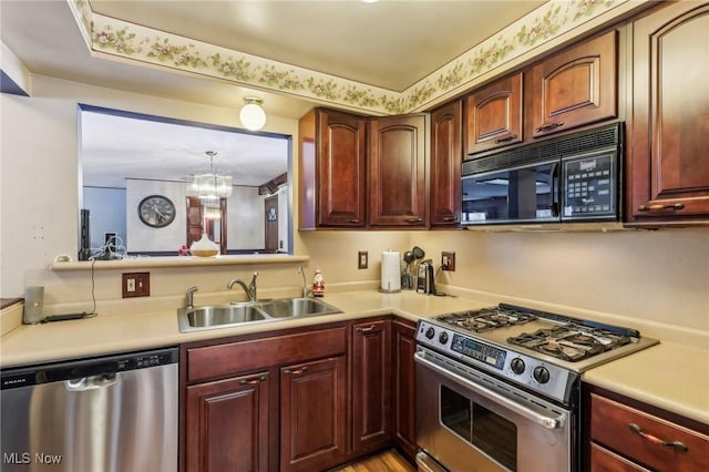 kitchen with an inviting chandelier, appliances with stainless steel finishes, and sink