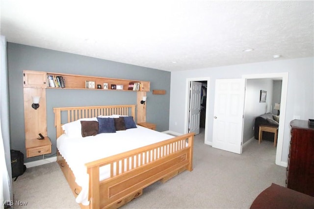 carpeted bedroom with a spacious closet, baseboards, and a closet