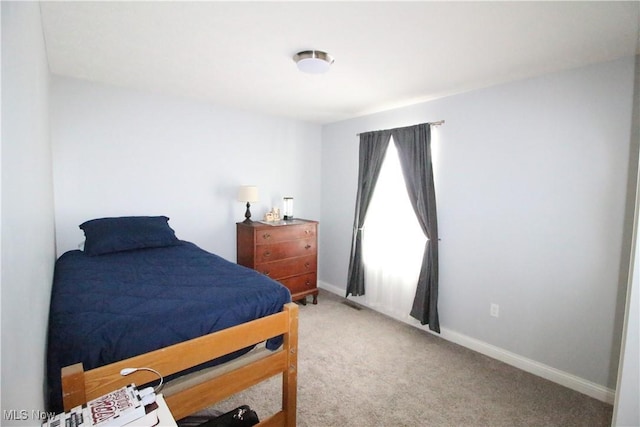 bedroom with baseboards and carpet flooring