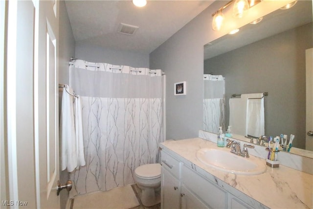 full bath with visible vents, toilet, curtained shower, and vanity