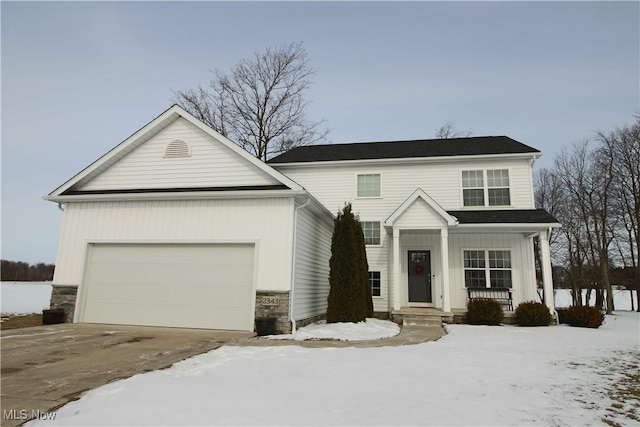 view of front facade featuring a porch, an attached garage, and driveway