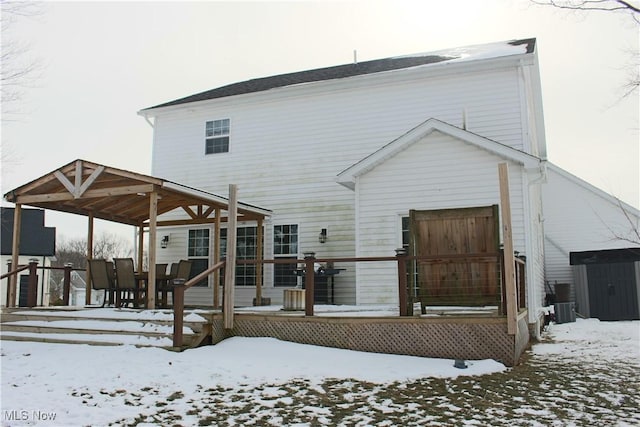 view of snow covered rear of property