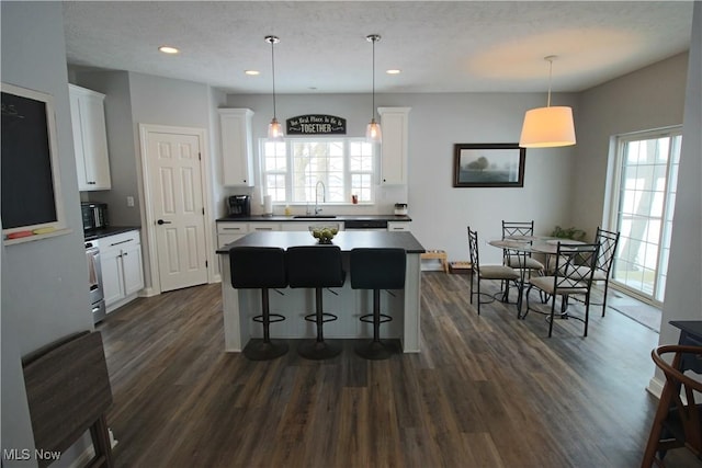 kitchen with dark countertops, dark wood-style floors, and a wealth of natural light