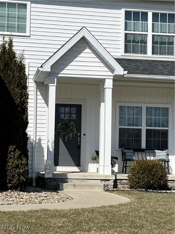 doorway to property featuring covered porch