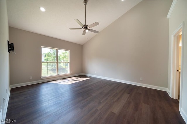 spare room featuring vaulted ceiling, dark wood-type flooring, and ceiling fan