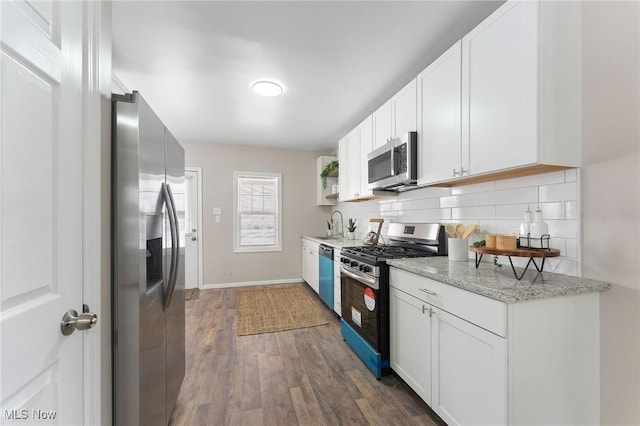 kitchen featuring white cabinetry, backsplash, and stainless steel appliances